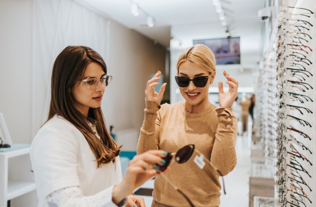 An eye doctor helps a patient find perfectly fitting sunglasses.