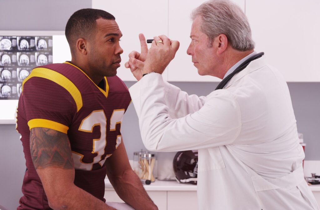 an eye doctor checking a patient's eyes for concussion symptoms.